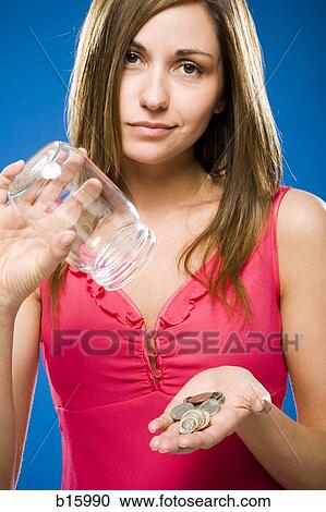 Woman emptying coins from jar into hand View Large Photo Image Stock Image - Woman emptying coins from jar into hand. Fotosearch