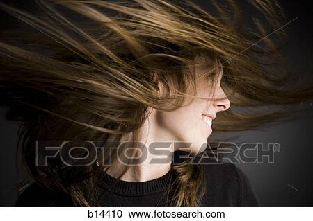 Stock Image - Woman flipping hair. Fotosearch