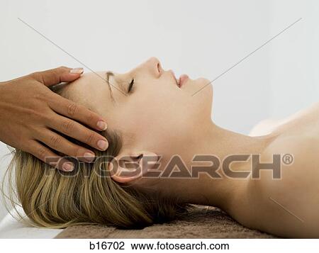 Stock Image - Woman getting head massage. Fotosearch