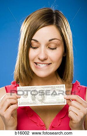Woman holding American hundred dollar bill View Large Photo Image Stock Image - Woman holding American hundred dollar bill. Fotosearch