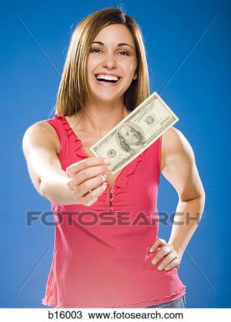Woman holding American hundred dollar bill View Large Photo Image Stock Image - Woman holding American hundred dollar bill. Fotosearch