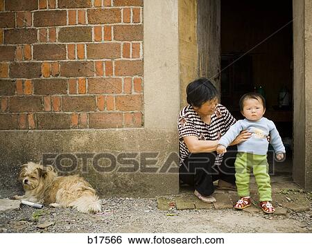 Woman holding baby outdoors with dog View Large Photo Image Stock Photograph - Woman holding baby outdoors with dog. Fotosearch