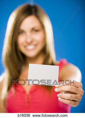 Woman holding blank card smiling View Large Photo Image Stock Photograph - Woman holding blank card smiling. Fotosearch