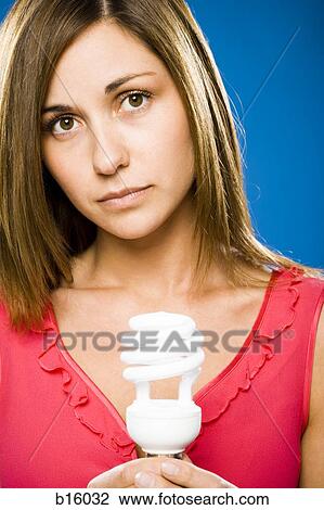 Woman holding energy efficient lightbulb View Large Photo Image Stock Image - Woman holding energy efficient lightbulb. Fotosearch