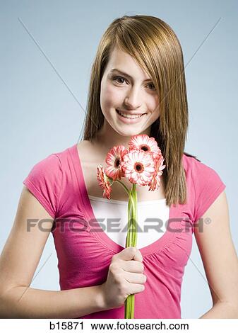 Woman holding flowers smiling View Large Photo Image Stock Image - Woman holding flowers smiling. Fotosearch