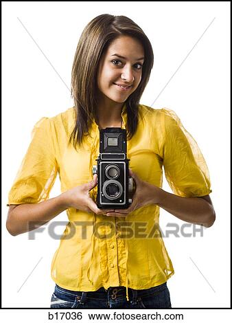 Woman holding old fashioned camera smiling View Large Photo Image Stock Photograph - Woman holding old fashioned camera smiling. Fotosearch