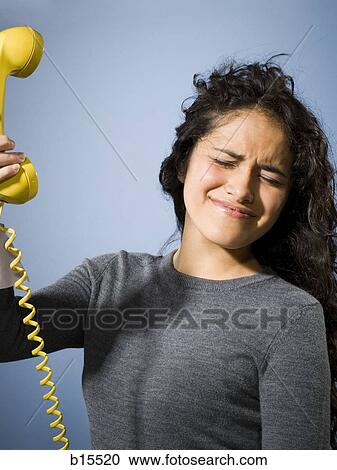 Woman holding phone away View Large Photo Image Stock Image - Woman holding phone away. Fotosearch