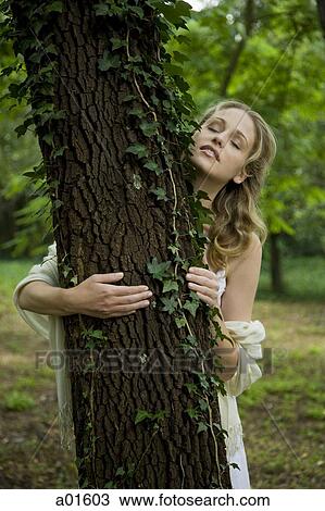 Woman hugging tree with eyes closed View Large Photo Image Stock Image - Woman hugging tree with eyes closed. Fotosearch