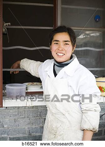 Woman in apron outdoors leaning and smiling View Large Photo Image Stock Image - Woman in apron outdoors leaning and smiling. Fotosearch