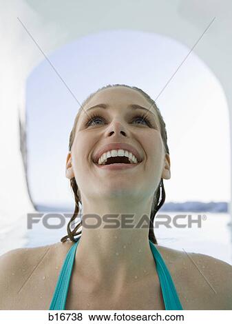 Woman in bathing suit with wet hair smiling View Large Photo Image Stock Photo - Woman in bathing suit with wet hair smiling. Fotosearch