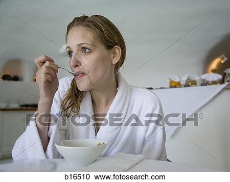 Woman in bathrobe eating cereal View Large Photo Image Stock Image - Woman in bathrobe eating cereal. Fotosearch