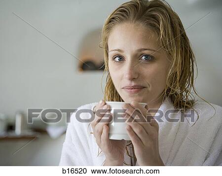 Woman in bathrobe holding mug View Large Photo Image Stock Image - Woman in bathrobe holding mug. Fotosearch
