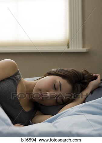 Woman in bed sleeping View Large Photo Image Picture - Woman in bed sleeping. Fotosearch