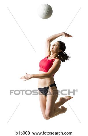 Woman in bikini jumping and playing volleyball View Large Photo Image Stock Photo - Woman in bikini jumping and playing volleyball. Fotosearch
