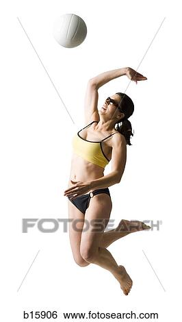 Woman in bikini jumping and playing volleyball View Large Photo Image Stock Photograph - Woman in bikini jumping and playing volleyball. Fotosearch