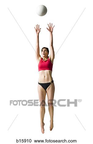 Woman in bikini playing volleyball and jumping View Large Photo Image Stock Image - Woman in bikini playing volleyball and jumping. Fotosearch