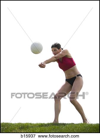 Woman in bikini playing volleyball outdoors on grass View Large Photo Image Stock Photo - Woman in bikini playing volleyball outdoors on grass. Fotosearch
