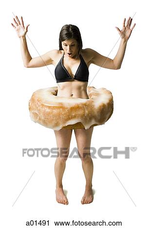Woman in bikini with donut around waist and arms up surprised View Large Photo Image Stock Image - Woman in bikini with donut around waist and arms up surprised. Fotosearch