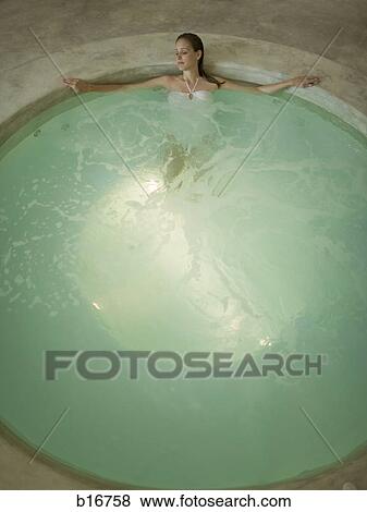 Stock Photo - Woman in hot tub indoors. Fotosearch