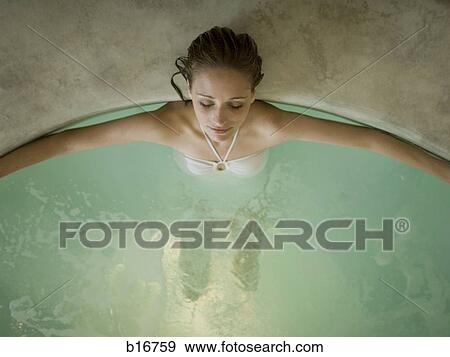 Stock Photo - Woman in hot tub indoors. Fotosearch