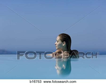 Woman in infinity pool reflection View Large Photo Image Stock Image - Woman in infinity pool reflection. Fotosearch