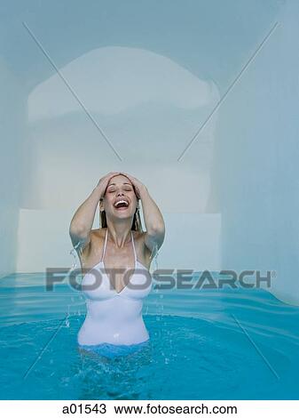 Stock Image - Woman in pool smiling. Fotosearch