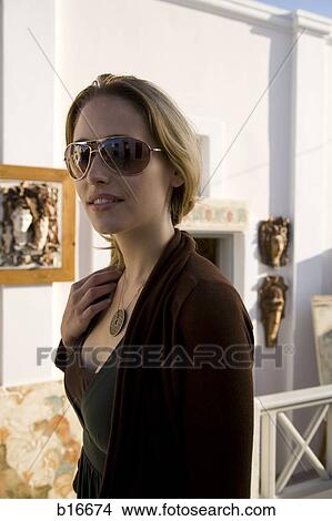 Woman in sunglasses outdoors smiling View Large Photo Image Picture - Woman in sunglasses outdoors smiling. Fotosearch