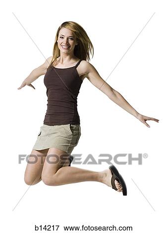 Woman jumping and smiling View Large Photo Image Stock Photo - Woman jumping and smiling. Fotosearch