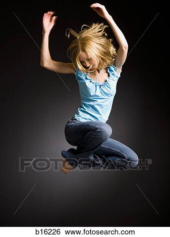 Woman jumping with arms up View Large Photo Image Stock Photograph - Woman jumping with arms up. Fotosearch