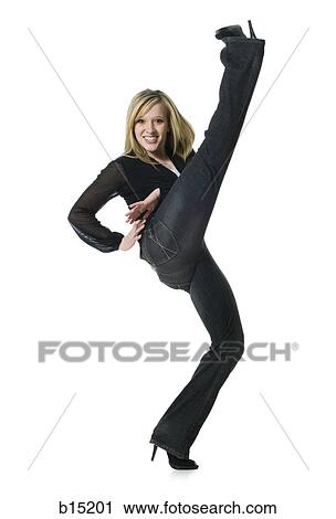 Woman kicking leg up and smiling View Large Photo Image Stock Image - Woman kicking leg up and smiling. Fotosearch
