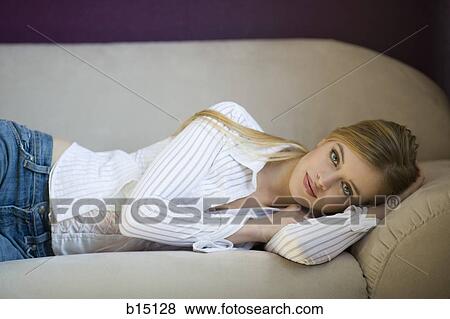 Stock Photo - Woman laying on sofa. Fotosearch