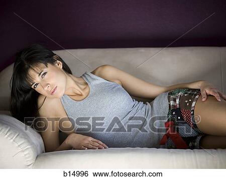 Woman laying on sofa View Large Photo Image Stock Photograph - Woman laying on sofa. Fotosearch