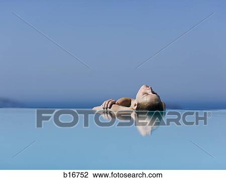 Woman leaning back in outdoor pool reflection View Large Photo Image Stock Image - Woman leaning back in outdoor pool reflection. Fotosearch