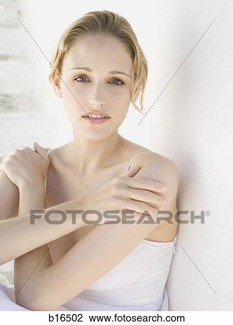 Woman leaning on wall with hands on shoulders View Large Photo Image Stock Image - Woman leaning on wall with hands on shoulders. Fotosearch