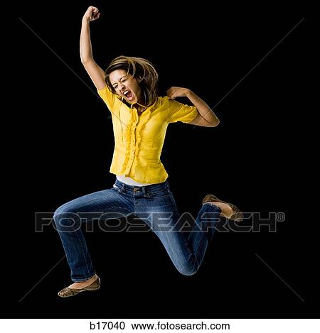Woman leaping with arms raised View Large Photo Image Stock Image - Woman leaping with arms raised. Fotosearch