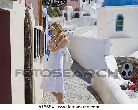 Woman looking at wall outdoors in village View Large Photo Image Picture - Woman looking at wall outdoors in village. Fotosearch