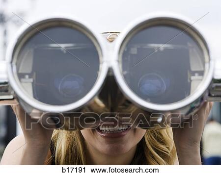 Woman looking through coin operated binoculars smiling View Large Photo Image Stock Image - Woman looking through coin operated binoculars smiling. Fotosearch