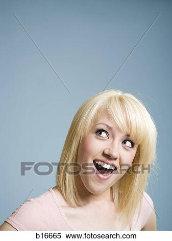 Woman looking up with mouth open smiling View Large Photo Image Stock Photography - Woman looking up with mouth open smiling. Fotosearch