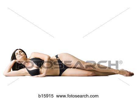 Woman lying down in bikini smiling View Large Photo Image Stock Photography - Woman lying down in bikini smiling. Fotosearch