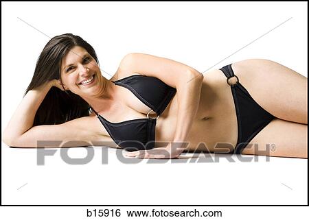Woman lying down in bikini with head resting on hand smiling View Large Photo Image Stock Photograph - Woman lying down in bikini with head resting on hand smiling. Fotosearch