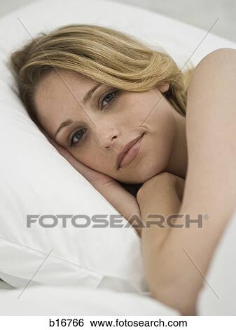Woman lying down smiling View Large Photo Image Stock Photograph - Woman lying down smiling. Fotosearch