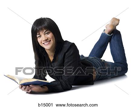 Woman lying down with hardcover book smiling View Large Photo Image Stock Image - Woman lying down with hardcover book smiling. Fotosearch