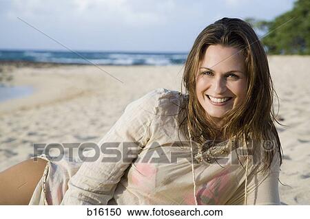 Stock Image - Woman on beach smiling. Fotosearch
