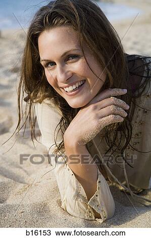 Stock Image - Woman on beach smiling. Fotosearch