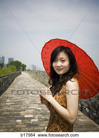 Woman on stone bridge with red parasol View Large Photo Image Picture - Woman on stone bridge with red parasol. Fotosearch