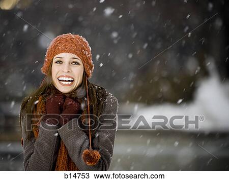 Stock Image - Woman outdoors in winter smiling. Fotosearch
