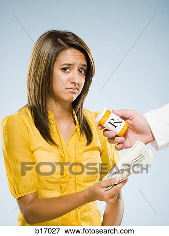 Woman paying for prescription View Large Photo Image Stock Photo - Woman paying for prescription. Fotosearch