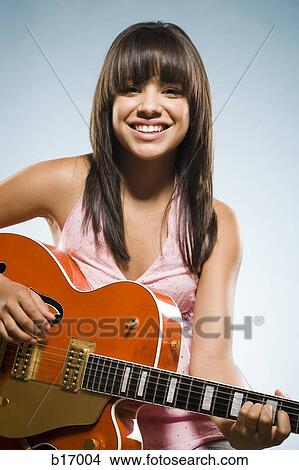 Woman playing guitar smiling View Large Photo Image Picture - Woman playing guitar smiling. Fotosearch