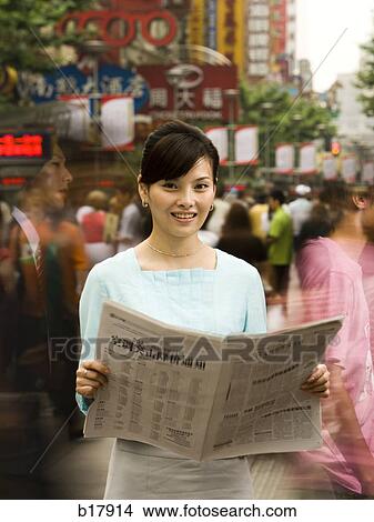 Picture - Woman reading a newspaper.. Fotosearch