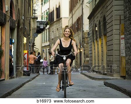 Woman riding a bicycle View Large Photo Image Stock Image - Woman riding a bicycle. Fotosearch